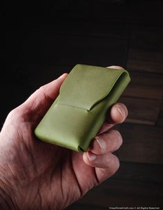 This green slim card holder is made of premium quality Vegetable-Tanned Crazy Horse-style leather from Italy. This wallet can hold up to 10 cards in the main compartment and features a pocket on the back for easy access to your cards or cash. Its slim profile does not include any buttons or rivets, making it sleek, simple, minimalist, and reliable. - Holds up to 10 cards in the main pocket. - Quick access pocket on the back for your cards or cash. - Slim profile with no buttons or rivets. - Size: 90 x 60 mm (3.54 x 2.36 inch). - Made of natural premium quality Crazy Horse style leather from Italy. - Multiple leather colors are available. - Veg-Tanned leather will change color and develop a patina as you use it. - Each card holder comes with an Italian Veg-Tanned leather quality certificate Green Trifold Wallet With Rfid Blocking As Gift, Green Rectangular Trifold Wallet With Rfid Blocking, Green Rfid Blocking Trifold Wallet, Green Bifold Card Holder As Gift, Green Rfid Blocking Card Holder Gift, Green Rectangular Trifold Wallet, Green Rectangular Card Holder For Personal Use, Engraved Wallet, Branding Iron