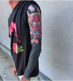 a man with tattoos on his arm and shoulder