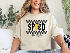 a woman sitting on a couch wearing a t - shirt that says speed