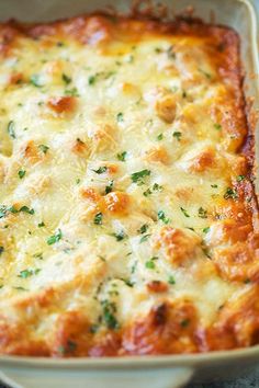 a casserole dish with cheese and parsley on the top is ready to be eaten