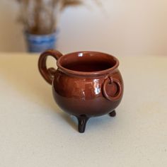 a brown cup sitting on top of a table