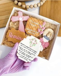 a box with some cookies in it and a person's hand next to it