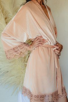 You and your bridal party will love being wrapped up in one of our beautiful robes on your wedding day. Made with a soft, luxurious velvet fabric & intricate lace detailing around the sleeves and bottom edge, our velvet robes are more than comfortable, they are stunningly beautiful & picture perfect. Ideal for giving or receiving as a gift, our robes are buttery soft & stretch to give you all the comfort you need as you lounge, sip mimosas, and get ready on your big day. Each robe is made with f Pink Bridesmaid Dress For Wedding, Pink Feminine Bridesmaid Dress For Wedding, Feminine Pink Bridesmaid Dress For Wedding, Pink Lace Bridesmaid Dress, Champagne Bridesmaid Dress For Wedding, Blush Gown For Weddings, Elegant Spring Bridal Shower Gown, Elegant Blush Wedding Gown, Elegant Peach Wedding Gown