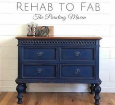 a blue dresser sitting on top of a wooden floor next to a white brick wall