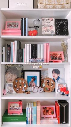 a white book shelf filled with lots of books and other items on top of it