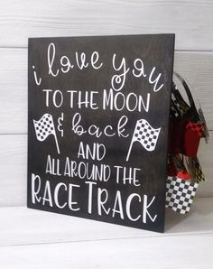 a sign that says i love you to the moon and back all around the race track