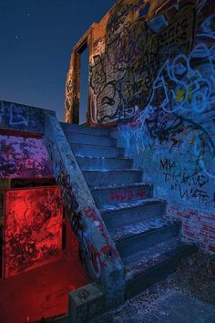 the stairs are covered in graffiti and red light