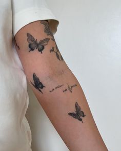 a woman's arm with butterflies on it