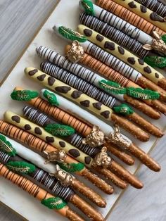 there are many different types of candy sticks on the table with chocolates in them