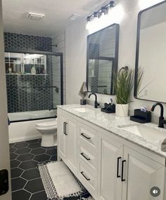 a bathroom with black and white tile flooring, two sinks, mirrors, and a toilet