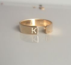 "Dainty and beautiful, this open 14 kt gold-filled personalized initial ring is great by itself or stacked. On each end you can have your first and last initials engraved, or simply the first initial of you and your loved one!! Approximately 4mm wide. If you prefer the stamped version of this ring, please click on this link below... https://www.etsy.com/listing/180684980/initial-ring-personalized-gold-ring Please don't forget to leave a message in the \"note to seller\" field upon checkout letti Adjustable Engraved Ring With Initials, 14k Gold Open Ring With Initials Jewelry, 14k Gold Open Ring Jewelry With Initials, Gold Initials Jewelry For Promise, Gold Promise Jewelry With Initials, Gold Jewelry With Initials For Promise, Customizable Gold Initial Ring, Wedding Initial Open Ring Stamped 14k, Gold Initials Promise Ring