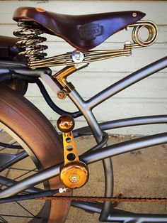 a close up of a bike tire and handlebars with a chain attached to it