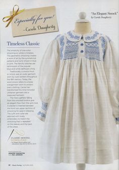 an advertisement for a baby's dress with blue trimmings and buttons on the collar