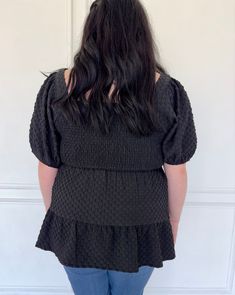 This black ruffled blouse is a plus size must-have. The puff sleeves add a touch of drama, while the textured woven fabric elevates its look. The square neck gives a flattering neckline to any outfit. Perfect for any occasion, this blouse is versatile and stylish. Black Ruffled Puff Sleeve Top, Chic Black Puff Sleeve Top With Ruffles, Black Fitted Puff Sleeve Top With Ruffles, Black Smocked Bodice Top With Square Neck, Chic Fitted Textured Blouse, Black Tops With Smocked Bodice And Square Neck, Chic Textured Fitted Blouse, Black Square Neck Top With Smocked Bodice, Black Puff Sleeve Top With Balloon Sleeves For Summer