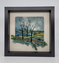 a painting with trees in the background and water on it's surface, framed in a black frame