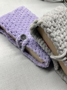 two crocheted book ends sitting next to each other on top of a table