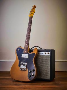 an electric guitar and amp sitting on the floor