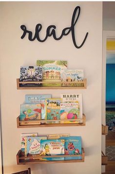 three wooden shelves with books on them and the word read spelled in cursive writing