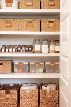 an organized pantry with wicker baskets and labels on the shelves, labeled with food