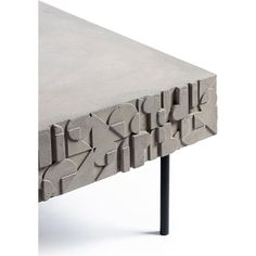 a table made out of concrete with different shapes and sizes on the top, sitting in front of a white background