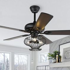 a ceiling fan in a living room next to a fireplace