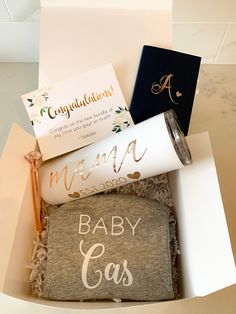 an open box filled with personal items for baby showering and congratulationss to the couple