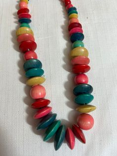 Vintage 80s Multicolor Necklace Colors Wooden Beaded.  Very good used condition Retro Beaded Necklace With Colorful Round Beads, Retro Multicolor Round Beaded Jewelry, Retro Multicolor Handmade Beaded Necklaces, Retro Multicolor Round Bead Jewelry, Retro Multicolor Round Beads Jewelry, Retro Multicolor Round Beads Necklace, Retro Colorful Beaded Necklace, Traditional Multicolor Wooden Beaded Necklaces, Retro Multicolor Beaded Necklace