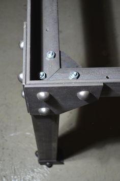 an industrial steel frame with rivets and screws on the bottom is shown