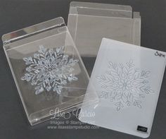 two clear boxes with snowflake designs on the front and one in the back