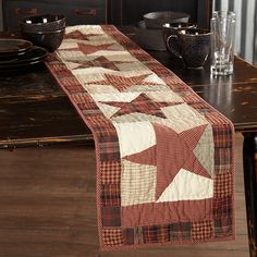 a table runner with a red and white star on it sitting on top of a wooden table