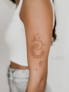 a woman's arm with a sunflower tattoo on the left side of her arm