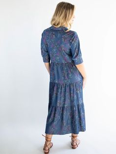 It’s no wonder that our Rebecca Midi Dress has been given over 2,000 FIVE STAR reviews! This all-time best seller is flattering for any shape and is super easy to wear - and now we have this Rebecca Tiered Dress made from a chambray fabric with a purple wisteria floral print! It’s fitted at the top with a buttoned bodice and a winsome empire waist. The high-low hem is ready to show off your favorite sandals, boots or heels. The rest of this tiered, chambray dress flows in a relaxed fit that keep Purple Wisteria, Chambray Fabric, Purple Midi Dress, Chambray Dress, Bohemian Clothes, Colorful Boho, Tiered Dress, Wisteria, High Low Hem