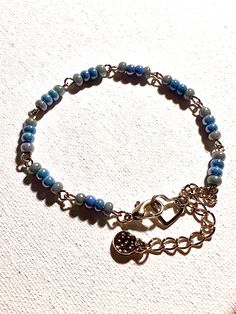 Pretty dainty sky blue glass seed bead bracelet, with lobster claw clasp. Also includes textured charm. This bracelet is made by linking together beaded wire creating a unique look. Great gift for your friend, wife, daughter, or anyone special in your life. Adjustable; fits 6.5-7.5 inch wrist, clip the clasp to heart or on any link for convenient adjustment. Two additional days needed for any special requests. Message me for more info. Dainty Blue Friendship Bracelets For Everyday, Adjustable Tiny Beads Charm Bracelet As A Gift, Adjustable Charm Bracelet With Tiny Beads As A Gift, Adjustable Charm Bracelet With Tiny Beads For Gift, Dainty Adjustable Bracelet With Lobster Clasp, Dainty Blue Bracelets With Tiny Beads, Adjustable Czech Glass Bracelets With Tiny Beads, Turquoise Beaded Bracelet As A Gift, Dainty Blue Adjustable Beaded Bracelets