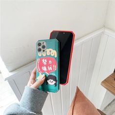 a person holding up a phone case with an animal sticker on it