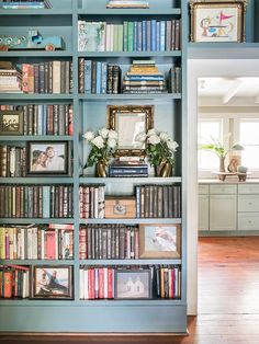 a bookshelf filled with lots of books next to a doorway