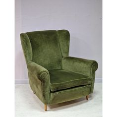 a green chair sitting on top of a white floor