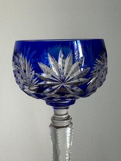 a blue glass bowl sitting on top of a table