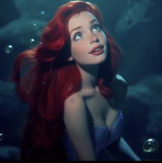 a woman with red hair is in the water