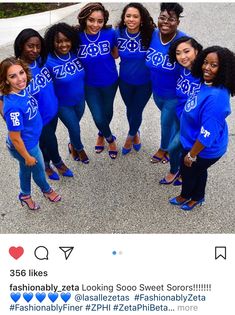 a group of women in blue shirts posing for a photo on the street with each other