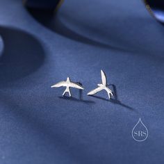 Sterling Silver Mismatched Asymmetric Swallow Bird Silhouette Stud Earrings - Fun, Whimsical and Pretty Jewellery.  Dimensions: Approx 13 x 11 mm.  These have textured brushed finish.  Made in sterling silver and available in three finishes： Silver, gold or rose gold  Possible to wear on the same ear as stacking earrings - depending on how far part your two piercings are.  ♥ All our jewellery comes with our branded velvet bag so your item is ready to be gifted. ♥ ★Free Shipping for UK orders, a Adjustable Silver Jewelry With Bird Design, Handmade Silver Wing-shaped Earrings, Vogel Silhouette, Stacking Earrings, Nickel-free Bird-shaped Earrings For Gifts, Silver Bird-shaped Earrings Gift, Second Piercing, Silver Bird-shaped Sterling Silver Necklace, Swallow Bird