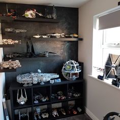 a room filled with lots of toys and shelves next to a wall mounted star wars action figures