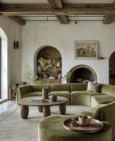 a living room filled with furniture and a fire place in the middle of the room