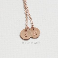 "Our tiny initial necklace is dainty and meaningful. This classic necklace is great for everyday wear or layering. Choose your number of discs and metal to wear your favorite initials close to your heart. D E T A I L S -Choose from 1-3 tiny discs -Disc measures 8mm -Choose 14kt Gold-Filled, Sterling Silver, or Rose Gold-Filled. -A high quality delicate link chain with a spring clasp. -Polished to a light satin finish. CUSTOM HAND STAMPING -Hand stamped with an initial. -This disc can also be lef Minimalist Rose Gold Hand Stamped Charm Necklaces, Minimalist Hand Stamped Rose Gold Charm Necklace, Minimalist Rose Gold Hand Stamped Charm Necklace, Dainty Adjustable Rose Gold Charm Necklace, Simple Rose Gold Charm Necklace For Everyday, Rose Gold Sterling Silver Initial Necklace With Delicate Chain, Rose Gold Initial Necklace With Delicate Chain, Dainty Rose Gold Necklaces With Initials, Delicate Rose Gold Initial Necklace For Everyday