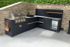 an outdoor kitchen with grill, sink and oven