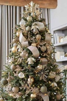 a christmas tree decorated with gold and silver ornaments