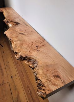 a wooden table with a very long section of wood on it's side,