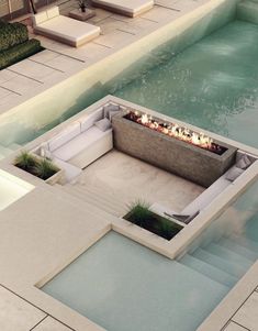 an outdoor fire pit in the middle of a swimming pool