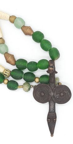 PEINTURE DE LOBI Tribal necklace with LOBI pendant,Bone Beads and green powder glas beads  . . . antique BONE beads,with carved pattern,about 45-50 years old, from Westafrica, various brass/messing beads from Westafrica ("lost form"), green KROBO beads (light - and dark green) made from powderglas, from Westafrica, 2 dark green beads made from antique glas, facet cut,from India, . . . a dream-beautiful pendant of the LOBI  (PROTECTION PENDANT) Total lenght incl. pendant : about 32.28 inch Pendan Spiritual Recycled Glass Beads For Gifts, Unique Hand-strung Green Beaded Necklaces, Green Beaded Necklaces With Recycled Glass For Gifts, Green Recycled Glass Beaded Necklaces For Gifts, Green Recycled Glass Beaded Necklace As Gift, Green Recycled Glass Beaded Necklace Gift, Green Round Bead Amulet Jewelry, Green Amulet Style Round Bead Jewelry, Green Amulet-style Round Bead Jewelry