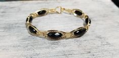 Beautiful Black Onyx faceted gemstones wrapped in Luscious 14kt Gold Filled wire. Elegant Onyx Wire Wrapped Jewelry, Elegant Wire Wrapped Round Beaded Bracelets, Elegant Wire Wrapped Bracelet Jewelry, Elegant Wire Wrapped Bracelet, Elegant Onyx Bracelet With Faceted Beads, Elegant Onyx Bracelets With Faceted Beads, Formal Round Wire Wrapped Jewelry, Adjustable Oval Jewelry With Faceted Beads, Handmade Onyx Gold Jewelry