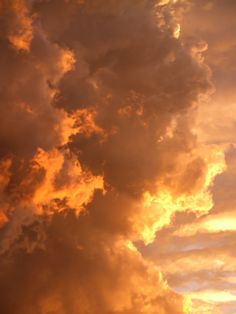 an airplane is flying in the sky at sunset or sunrise with clouds and sunbeams